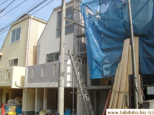 Squeezing not one, not two, but three houses into one small lot. Of course, there must be a cover