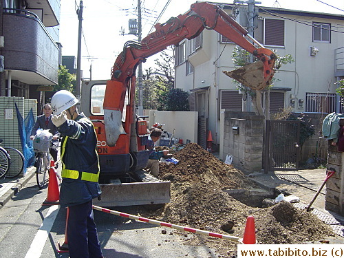 Construction worker showing pedestrians the way
