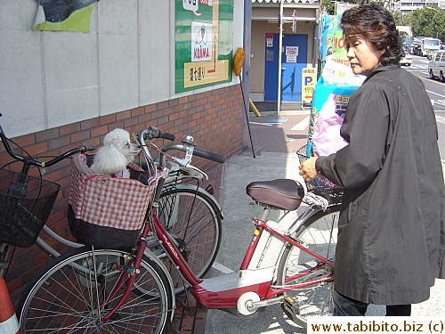 Woman leaving pet shop, did she get a treat for him?