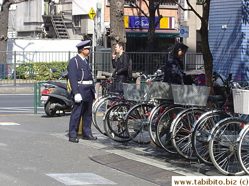 This supermarket guard's job is to thank shoppers and help them park or pull out their bicycles, that's all he does, all day