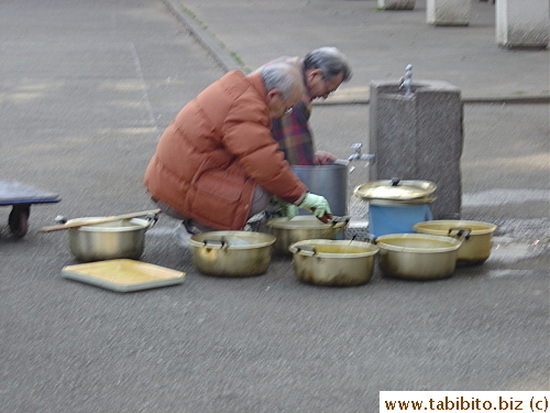 Homeless men washing pots in Ueno Park