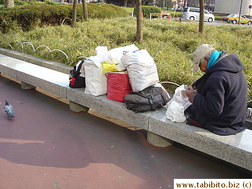 Homeless man and his belongings