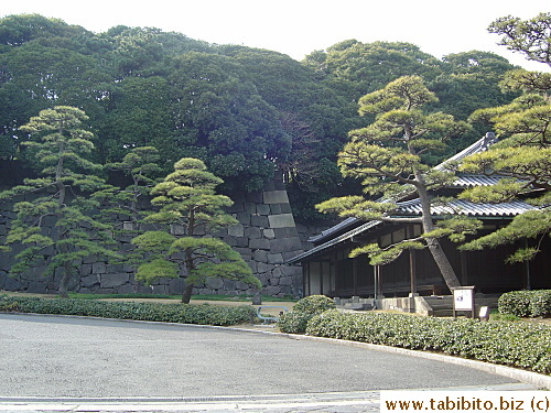 Pine trees, stone wall, and guardhouse create a perfect picture