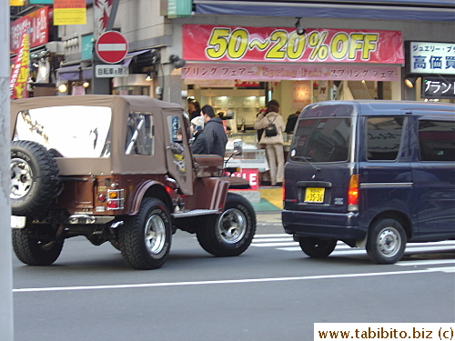 A jeep looks out of place in the midst of Ueno traffic