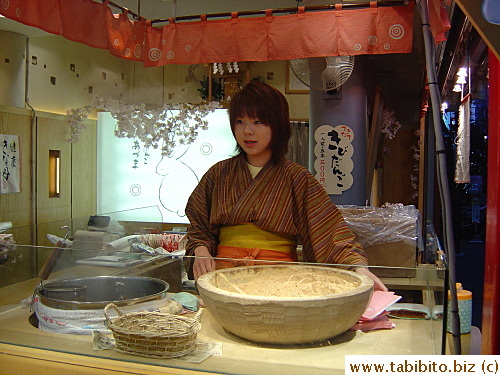 This snack stand manned by a woman dressed in kimono