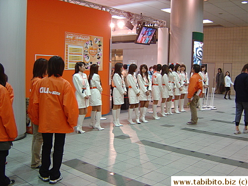 A row of young girls promoting for a phone company