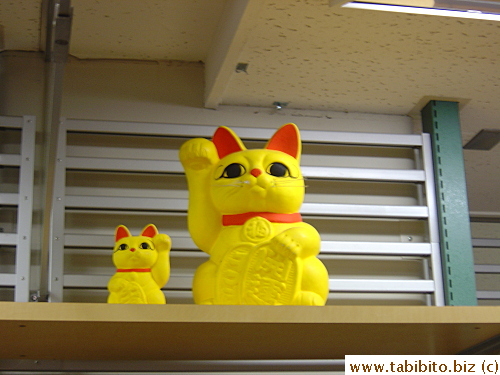 Loft in Kichijoji places a pair of manekineko on top of shelves all through the store