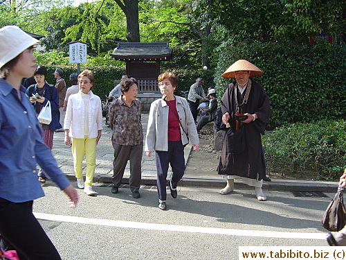 Monk asks for donation by ringing a small bell. The bowl is the receptacle