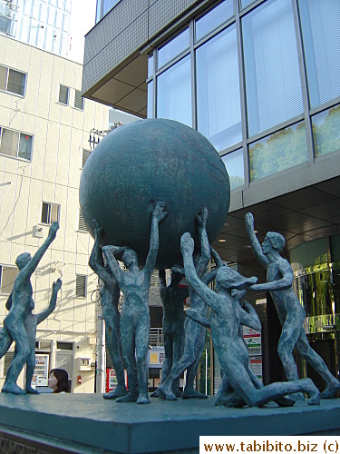 A soccer-fever-lookalike sculpture in front of a Japanese post office