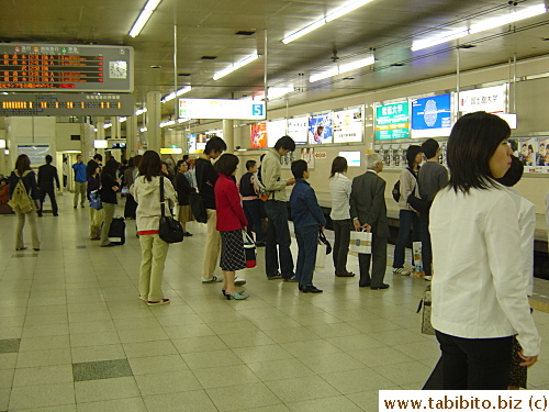 People dutifully line up for the train