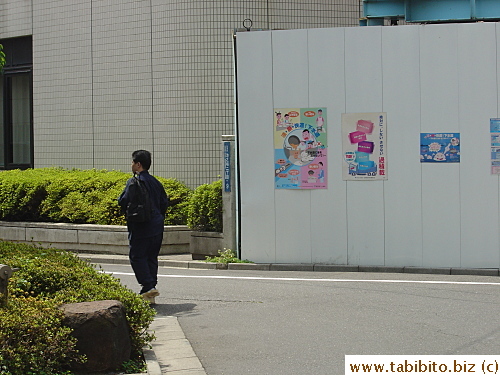 He turned just as I took this picture.  His mile-high wood sandals is obscured by the bush but still easy to see under his black socks. They go 