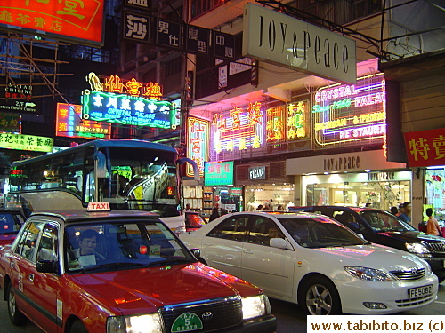 Neon and shop signs that stick right out onto the street