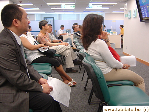 People waiting for their turns to go to the designated booth to complete the process of getting their HK Smart ID Cards