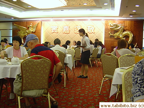 Traditional decorations in a yum cha restaurant: Pheonix and Dragon. They symbolize woman and man in a wedding reception dinner which is commonly held in yum cha restaurants