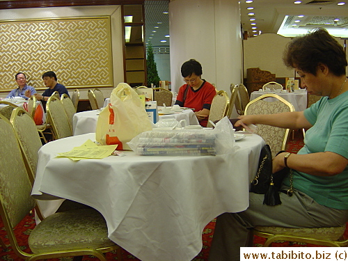 Many diners bring paper to a yum cha restaurant to read while they eat