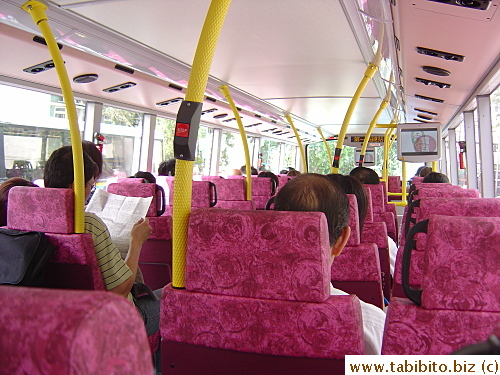 This upper deck of a bus has two TVs