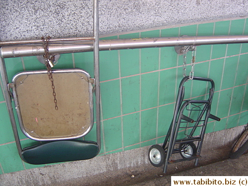 This chair is chained to a rail, do people really want to steal this rusty old chair?