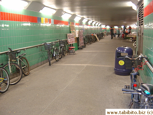 Bicycles parked and chained to rails inside an underground walkway