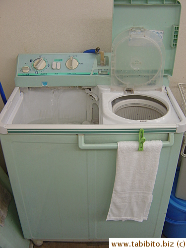 Very old-fashioned washing machine in the shop which is used to wash all towels used on clients