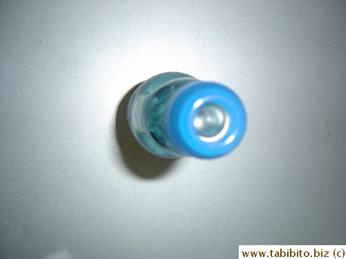 The marble is visible sitting quietly on top before the bottle is popped open
