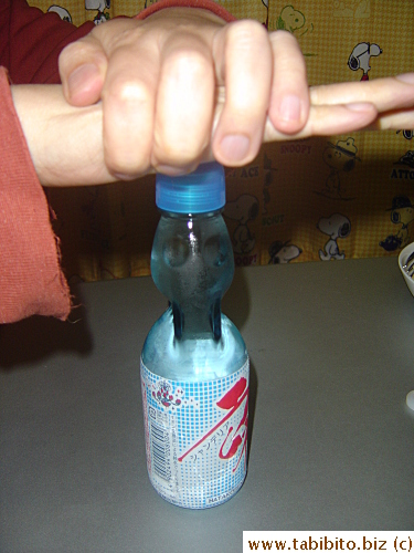KL used the pink thing over the white ring to push the marble down in the neck