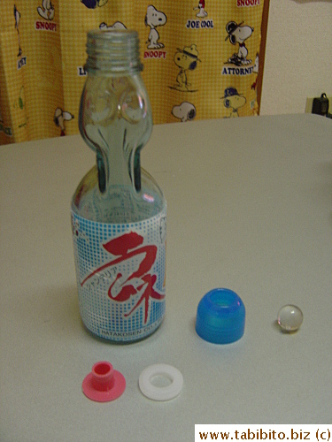 We got the marble out by twisting the screw-top clockwise