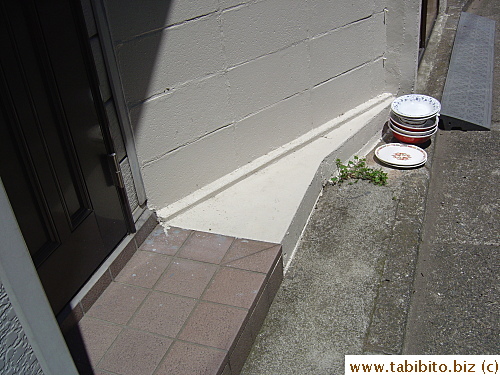 Empty bowls from home delivered ramen left outside the house to be collected by the ramen shop