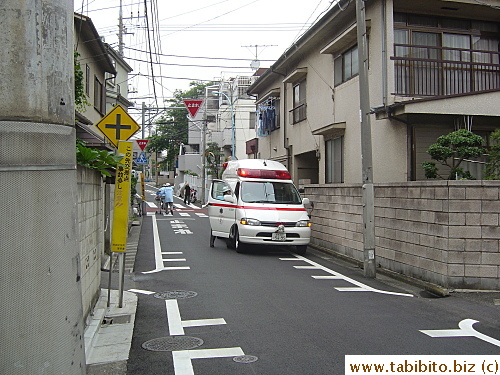 Paramedics (in blue uniforms in the distance) racing to save lives
