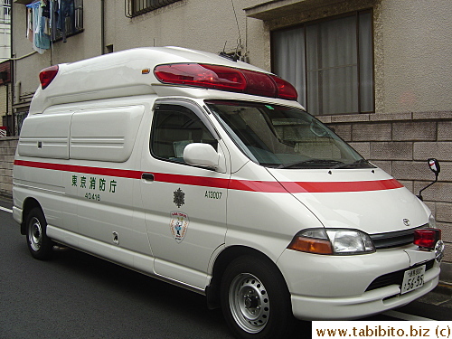 An empty ambulance.  Lights still flashing and ignition key inside