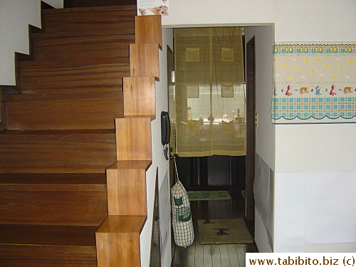 Staircase and hallway leading to the kitchen
