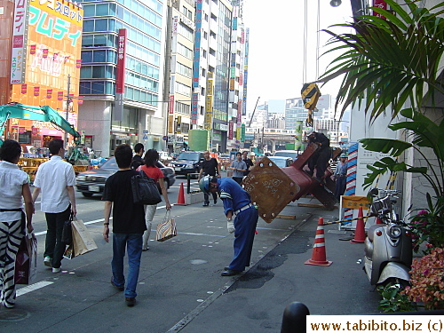 Worker apologizes to pedestrians for the inconvenience the construction work causes
