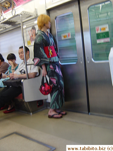 Spotted this woman in yukata on the train home from the airport. Notice the multiple phone straps on the cell phone tucked inside the sash