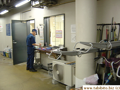The office inside the parking garage.  The staff deals with customers standing outside it