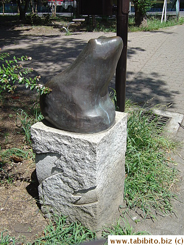 A frog statue on the walkway along the stream