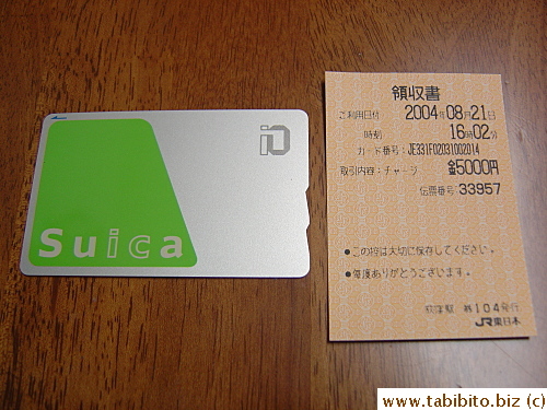 Suica card and the receipt for the money top-up in the ticket machine