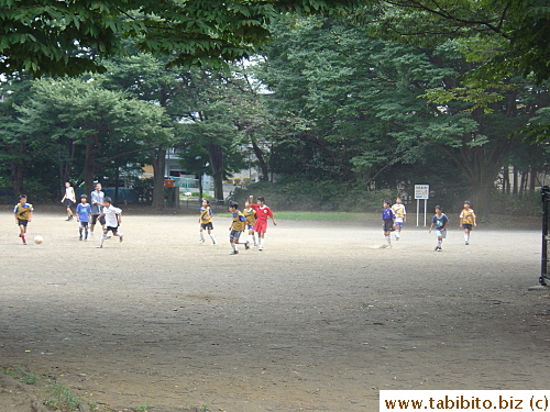 Kids playing a game of soccer in one of the many parks in our neighborhood