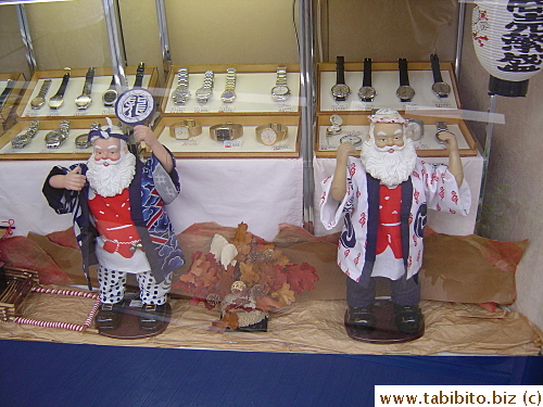 These dolls are dressed in the traditional festival coats. The character on the undershirts says 