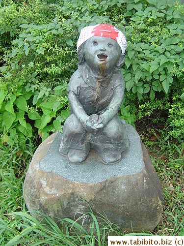 A spooky statue on our cycle route.  Someone has tied a bandana thing on its head with the word 
