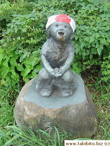 A spooky statue on our cycle route. Someone has tied a bandana thing on its head with the word