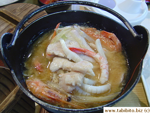 I dumped the raw tuna, shrimps, clams and squid into the very hot soup and covered the lid. After ten minutes it was completely cooked. All the other Japanese looked at me in awe/horror
