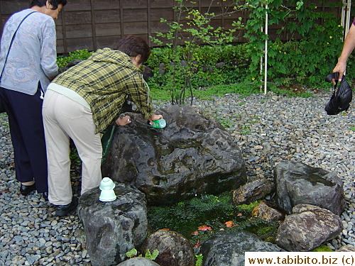 People who have their own bottles fill them up with the water from a natural underground spring right next to the sake building