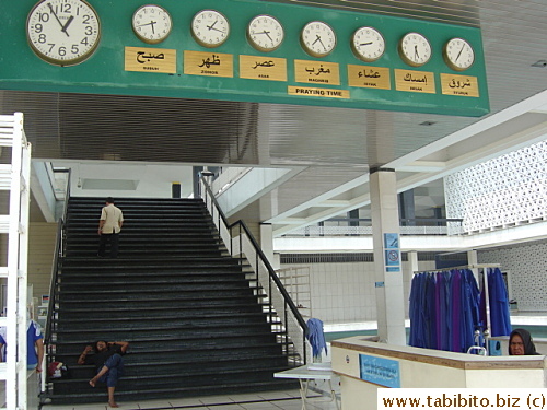 We visited the outside of the biggest mosque in kuala Lumpur.  The small clock on the left gives the time for sun rise, the one on far right tells the sun set time.  The five clocks in between gives the time for praying during the day.  The purple robes on the right side of the stairs are for women muslims to put on before entering the mosque