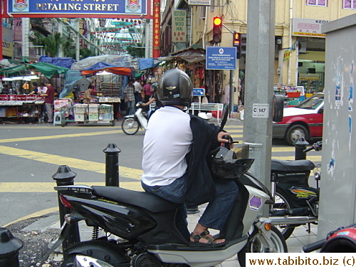 Many motor cyclists in Kuala Lumpur like to wear their jackets backwards while driving their motorbikes
