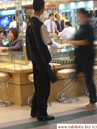 Many jewelry stores have security guards who carry a big long rifle to guard the store