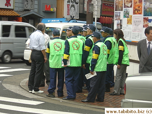 A group of workers patrol the streets for illegally-parked bicycles