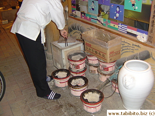 The owner prepares individual charcoal grill for diners