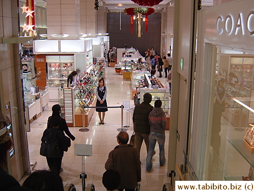 A staff on each floor stands behind the barricade and bows to leaving shoppers