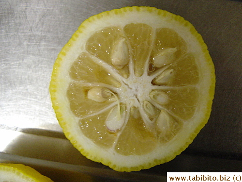 A yuzu cut in half