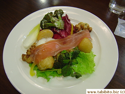 Warm salad with prosciutto and very soft-boiled egg