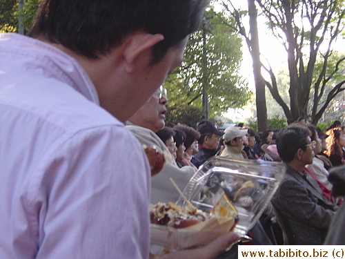 A man eating octopus balls